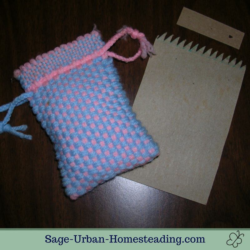 The piece of cardboard with spikes served as a loom inside the pouch as I made it. cardboard weaving loom